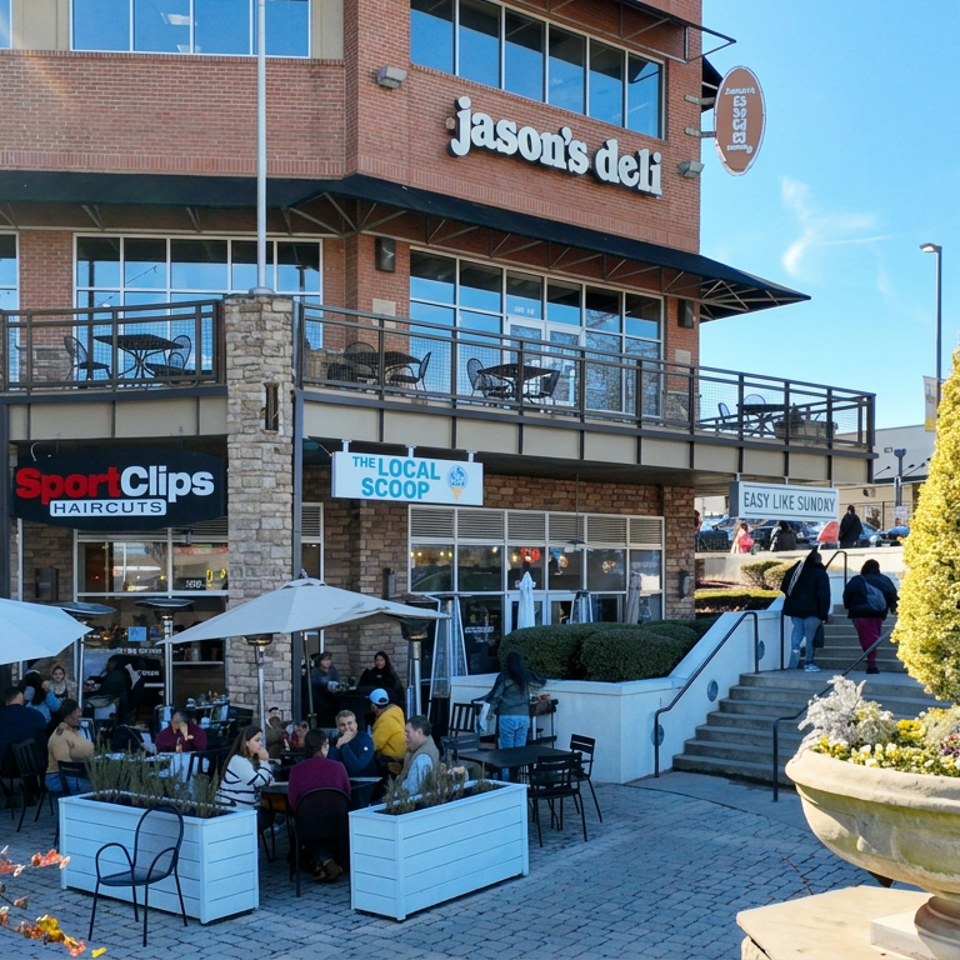 Jason’s Deli storefront with outdoor patio seating, umbrellas, diners, neighboring businesses, and landscaped plaza.